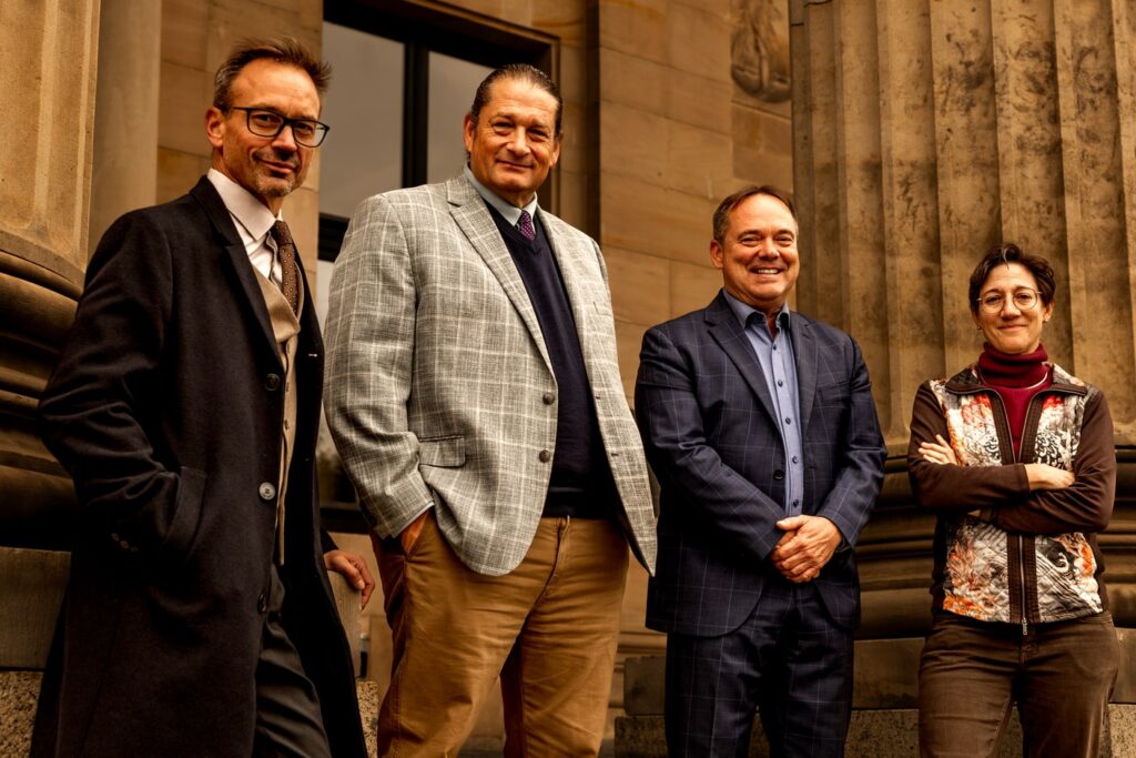 Group of military lawyers standing in front of a courthouse building