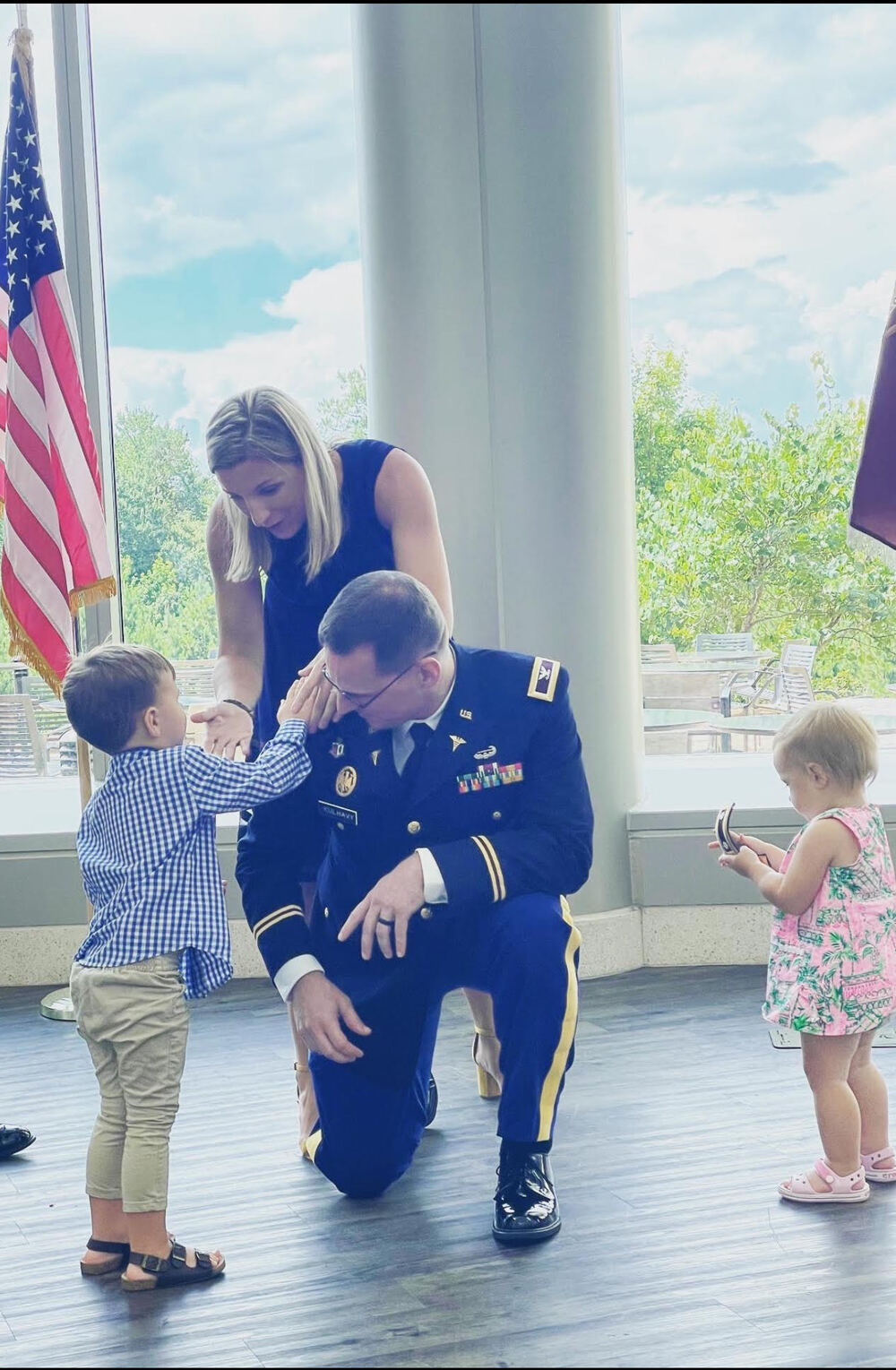Regan Kulhavy’s family at a military promotion ceremony with children