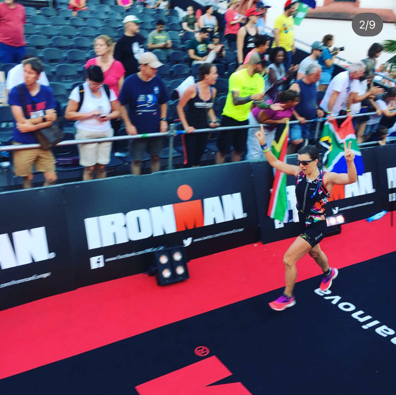 Regan Kulhavy celebrates as she crosses the Ironman finish line
