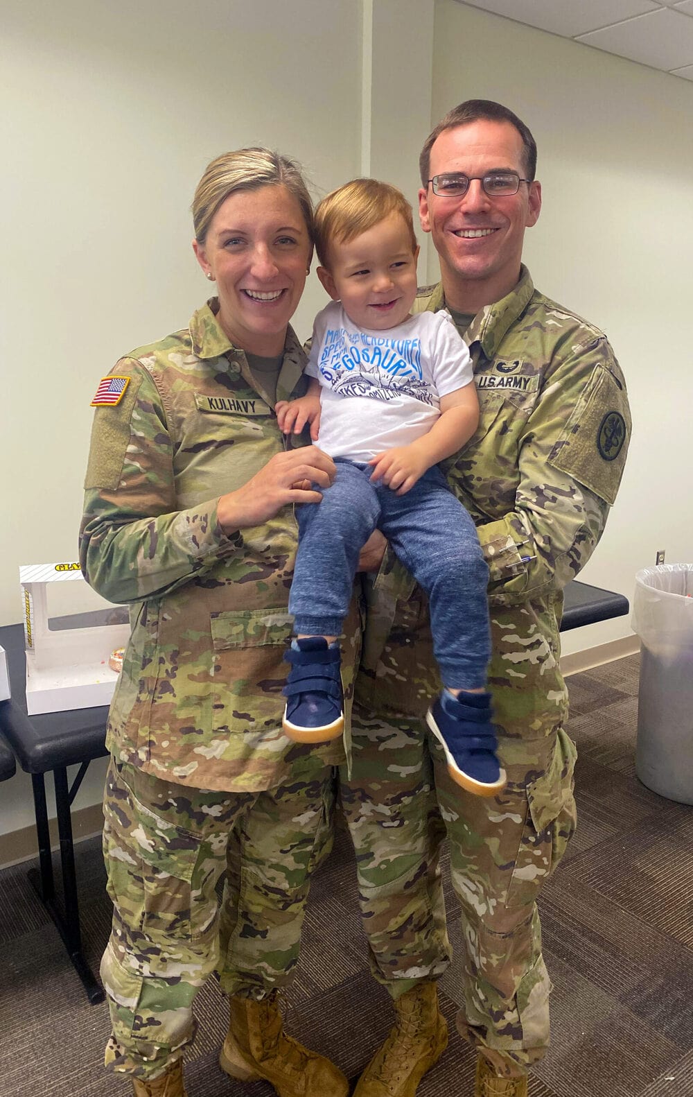 Regan Kulhavy with her husband and son in military uniforms