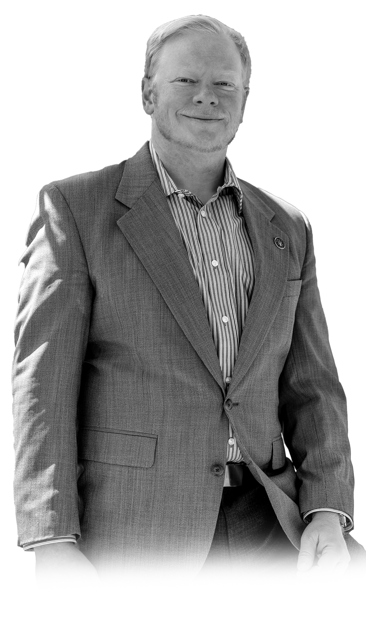 Cadman Kiker in gray suit jacket and collared shirt, black and white professional portrait