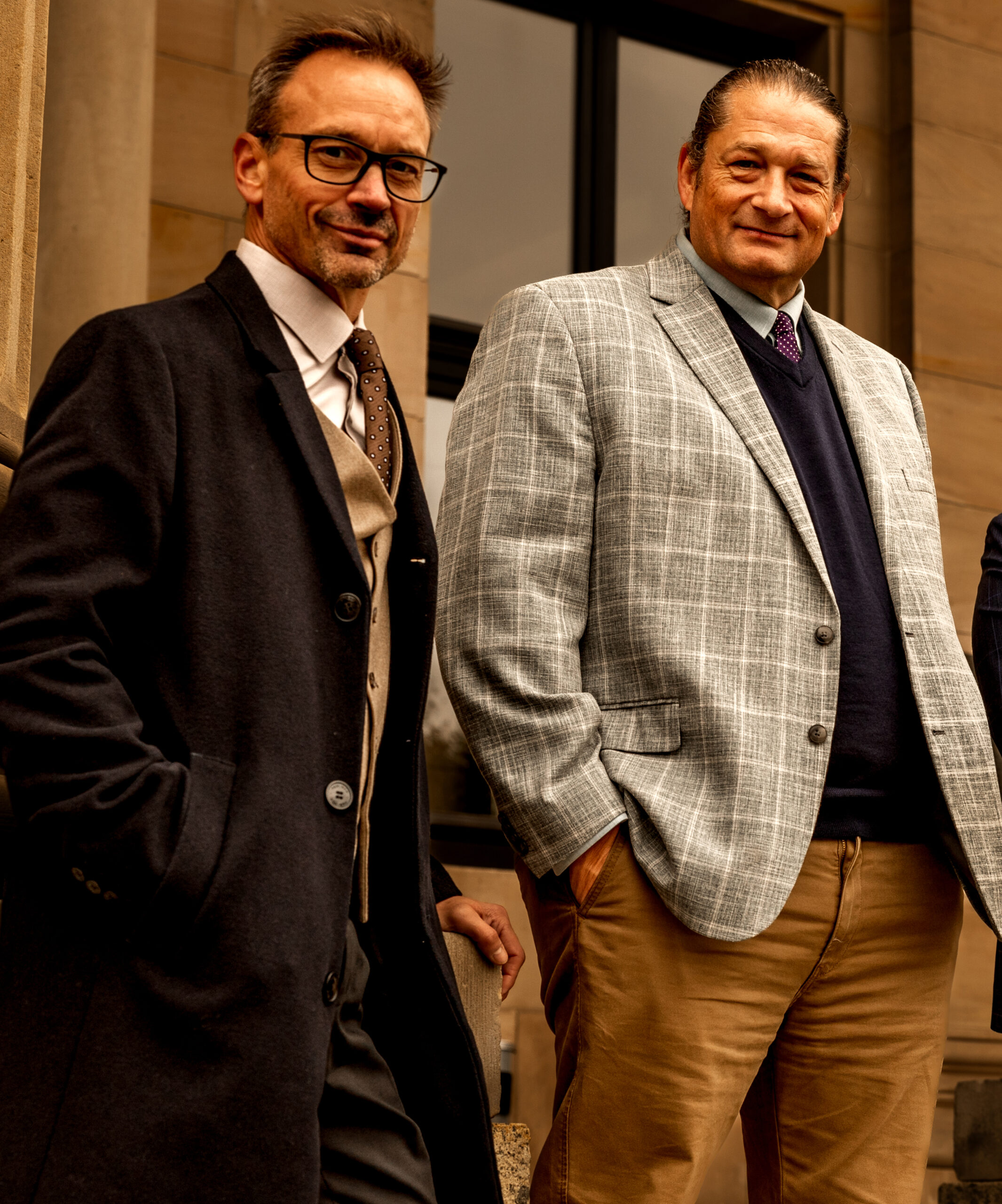 John Caulwell and Will M. Helixon standing together in front of a building dressed in business attire
