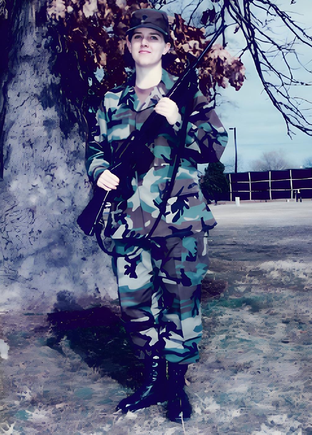 Kyle Meisner in camouflage uniform holding M16 rifle outdoors