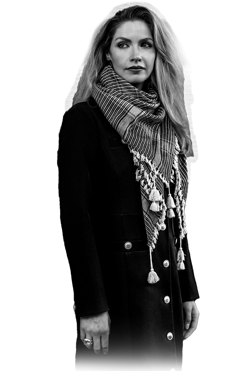 Black and white portrait of Laura Kiker in a dark coat and striped scarf, cut out on white background with faded lower edge