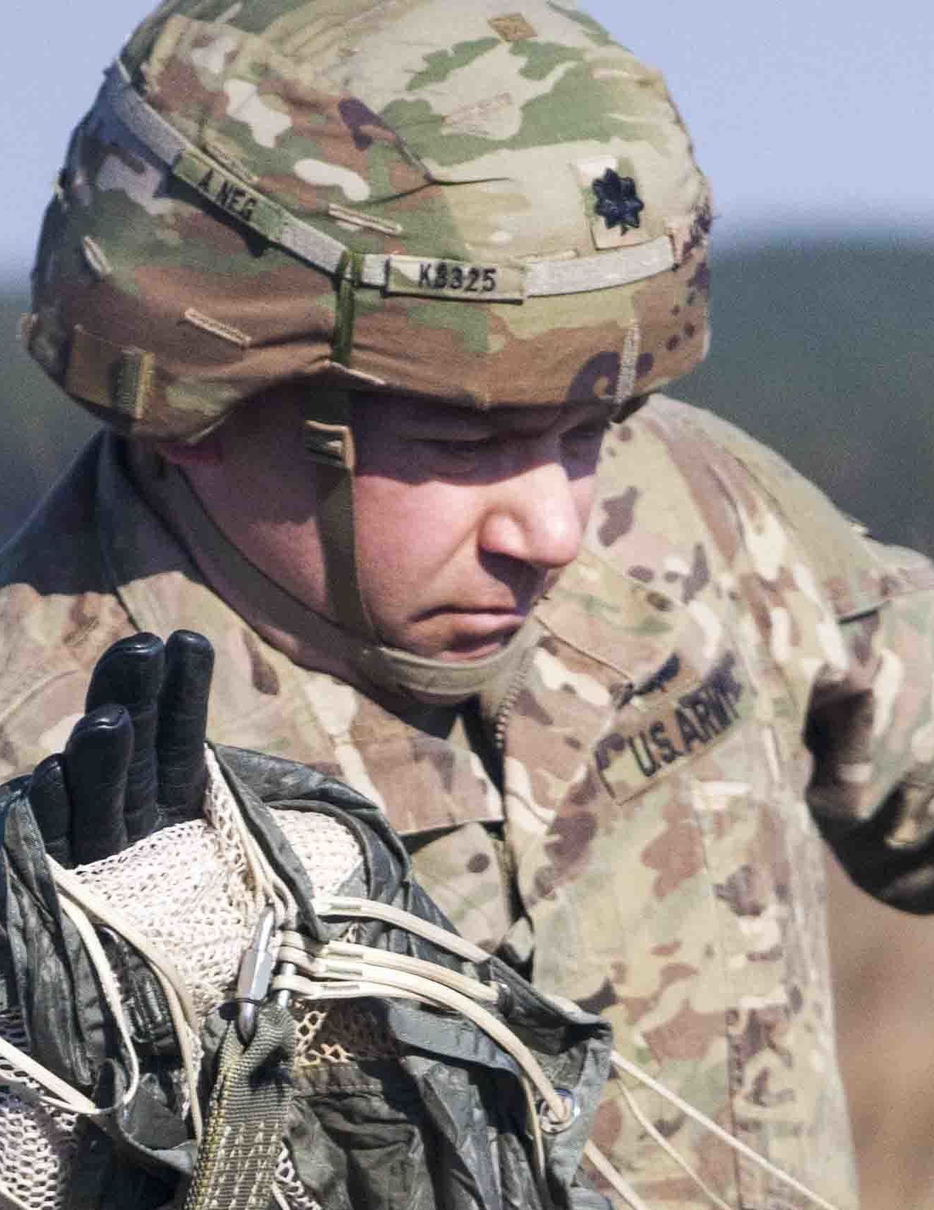 Matthew Krause in U.S. Army uniform holding parachute equipment