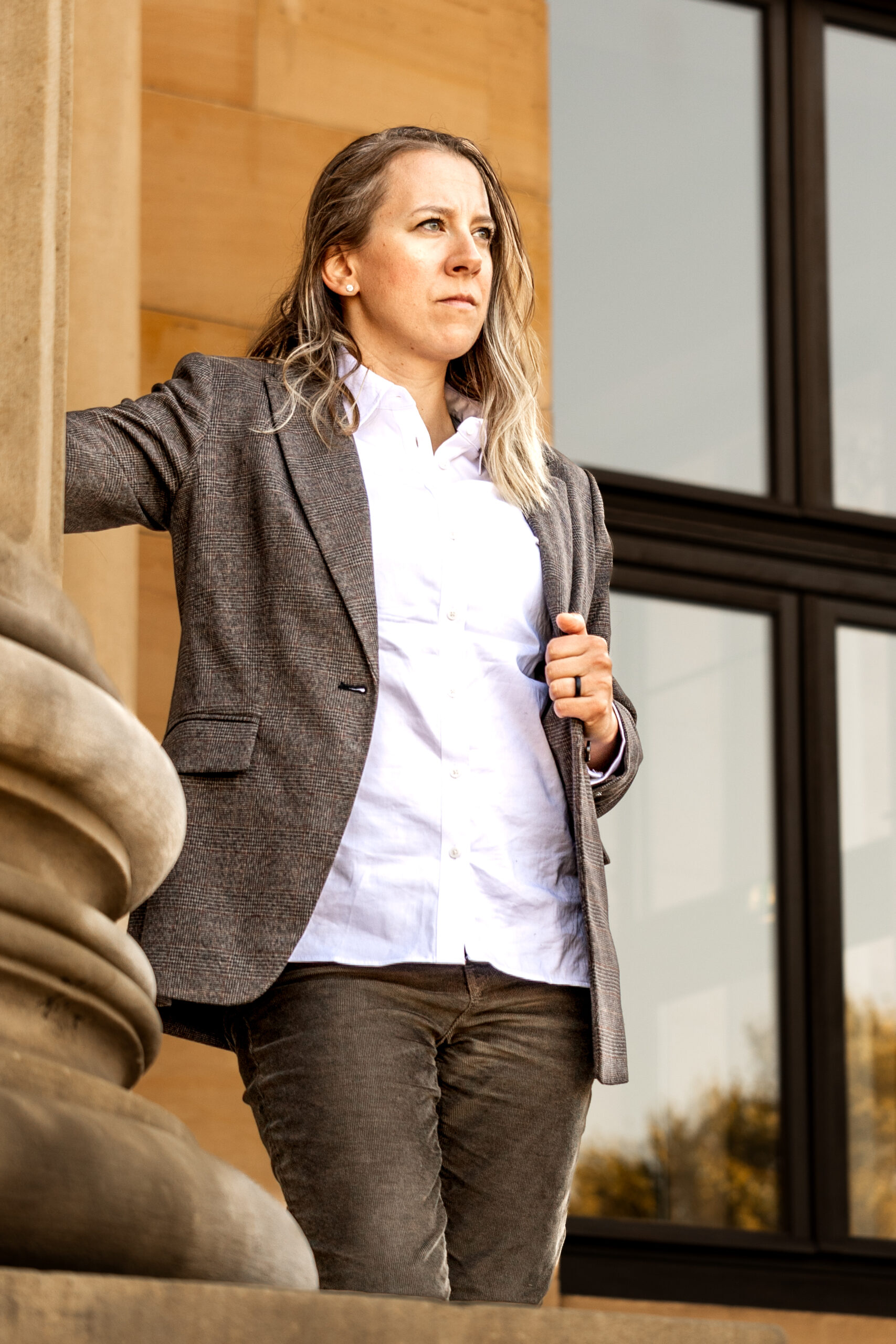 Natalia Helmsing standing with arms crossed beside a column in business jacket