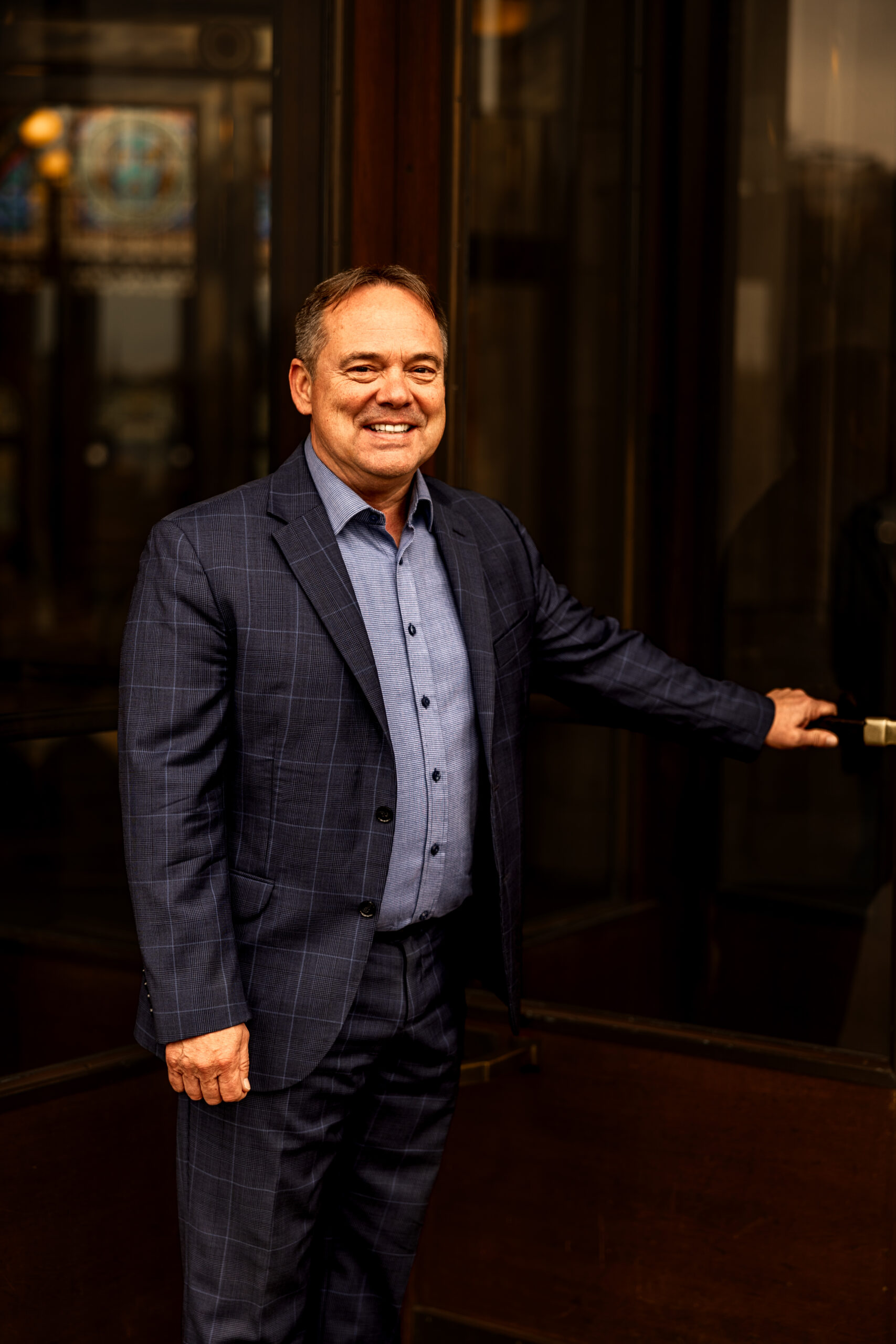 Scott Brokaw holding door handle at building entrance