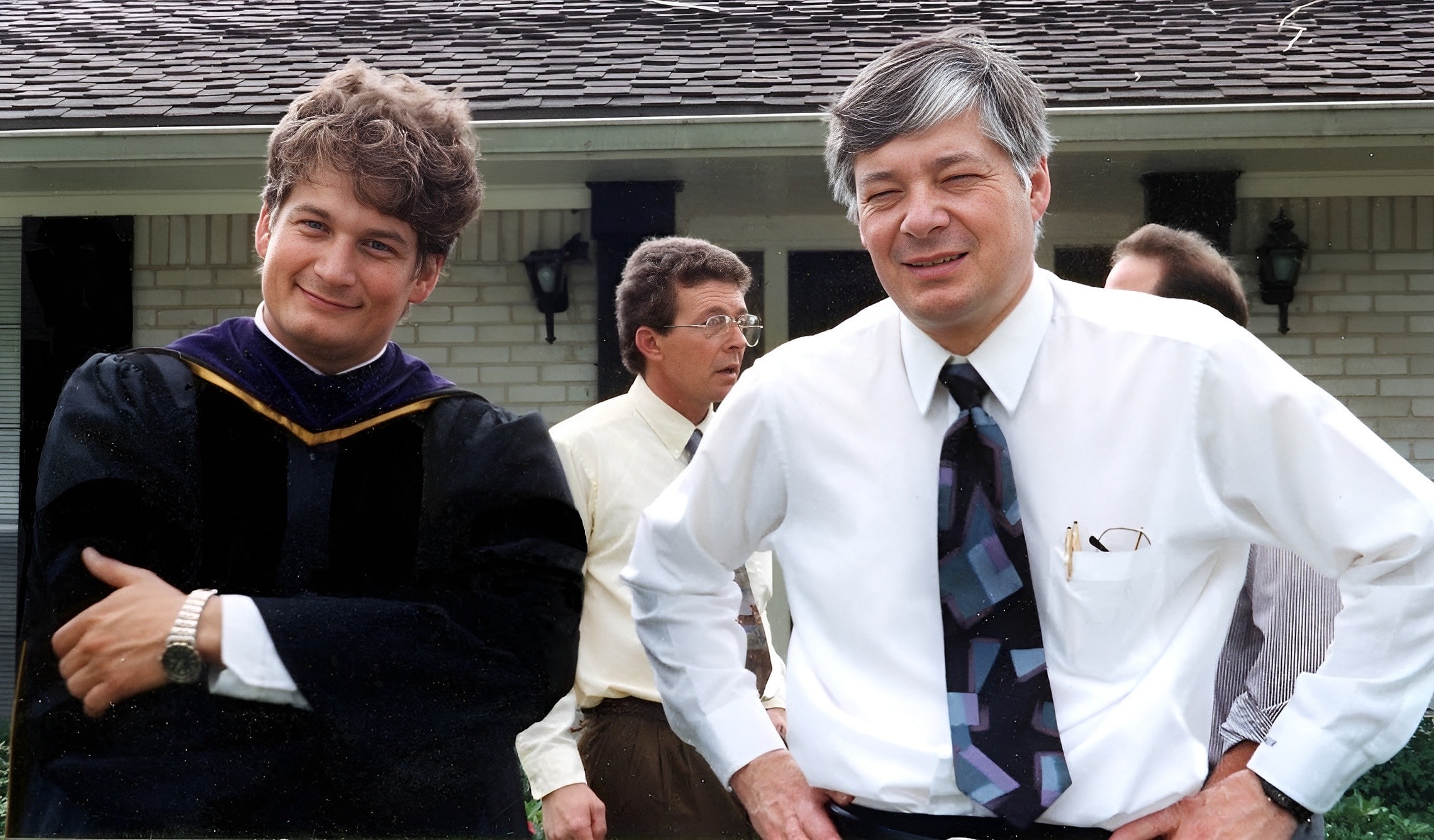 Will M. Helixon, founder of the LOWMH, posing with his father at an outdoor graduation