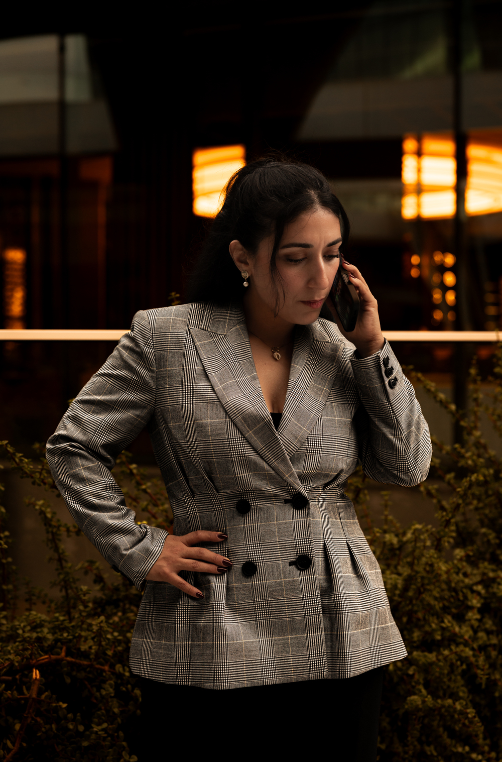 Military lawyer Linda Aguilera talking on the phone with a client outside an office building