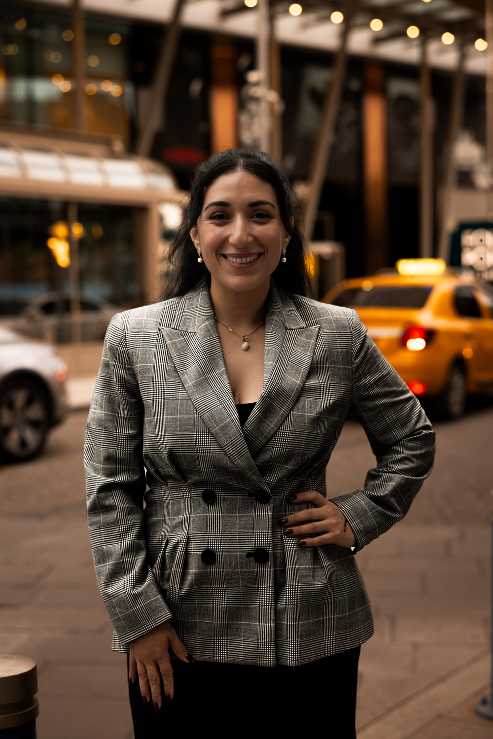 Military lawyer Linda Aguilera smiling with hand on hip on a city street in Izmir, Turkey